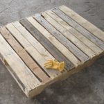 Wooden Pallet for rental unit with glove on top